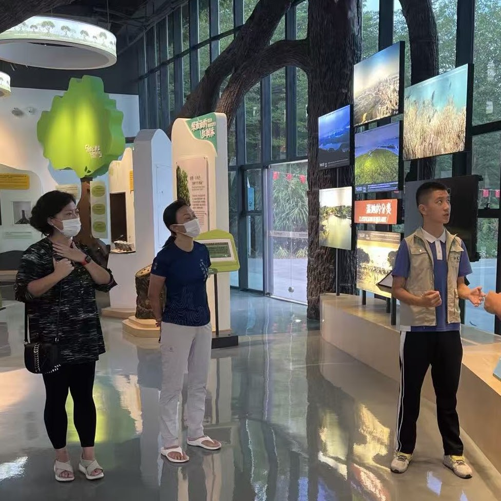 Explaining a wetland exhibit to young visitors